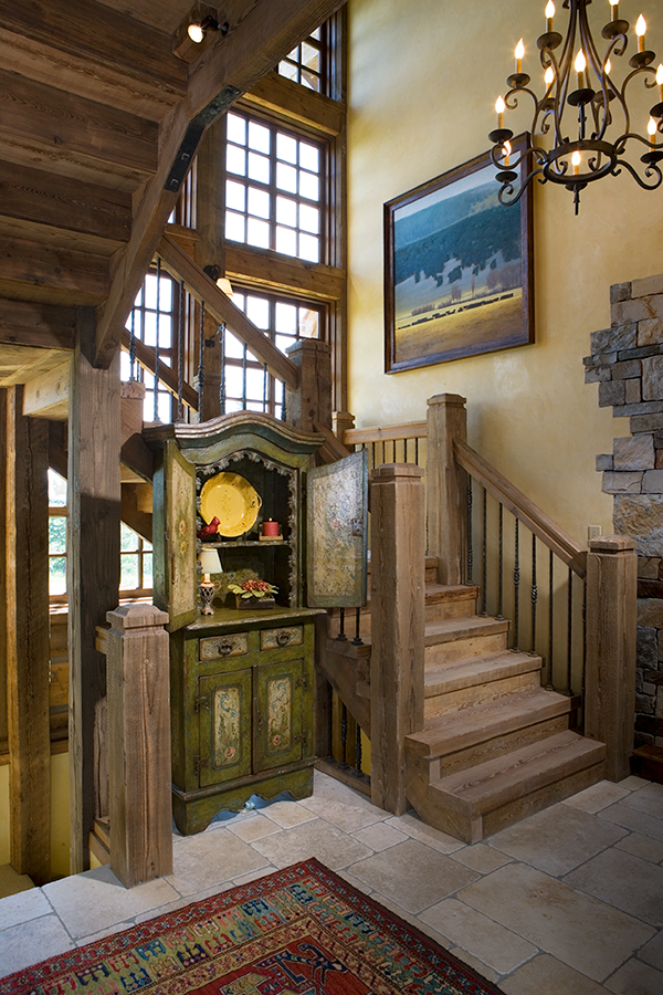 Wooden staircase leading upstairs and downstairs with decorative cabinet