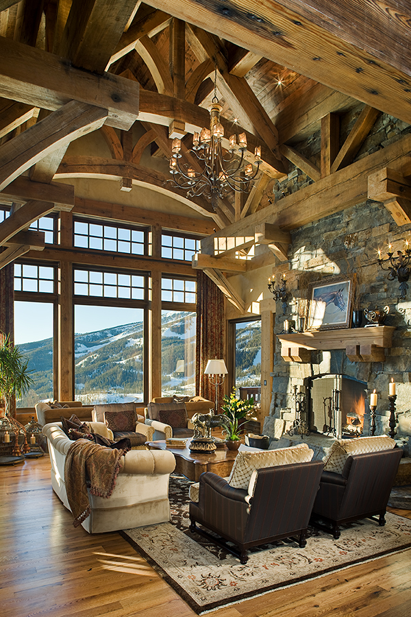 Grand living room with burning fireplace and hanging chandelier