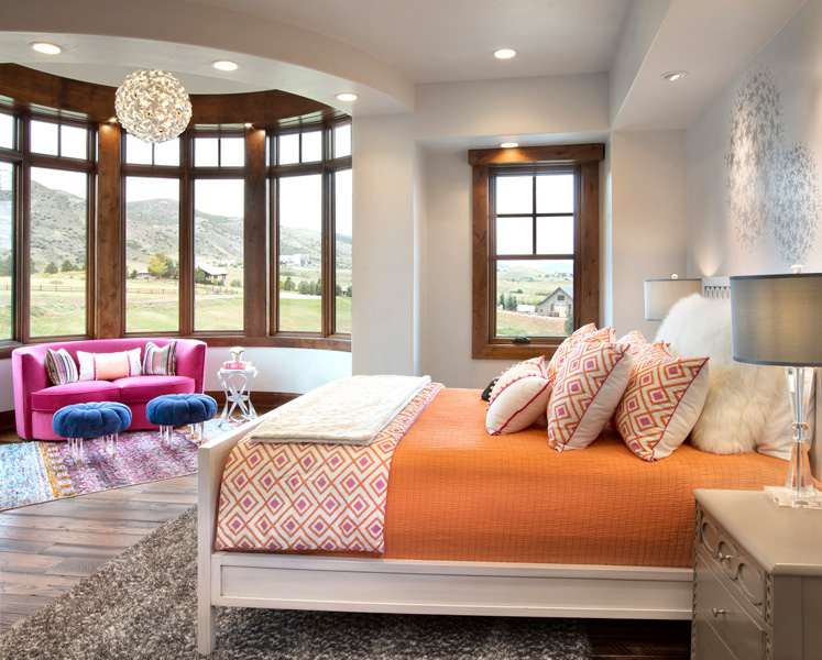 interior bedroom overlooking field pink couch and orange sheets