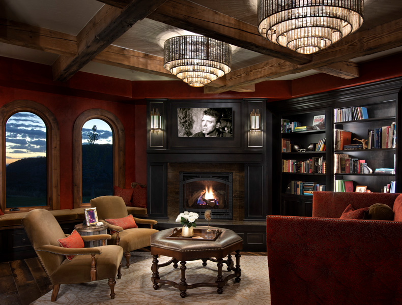 interior study with bookshelf fireplace and arch windows