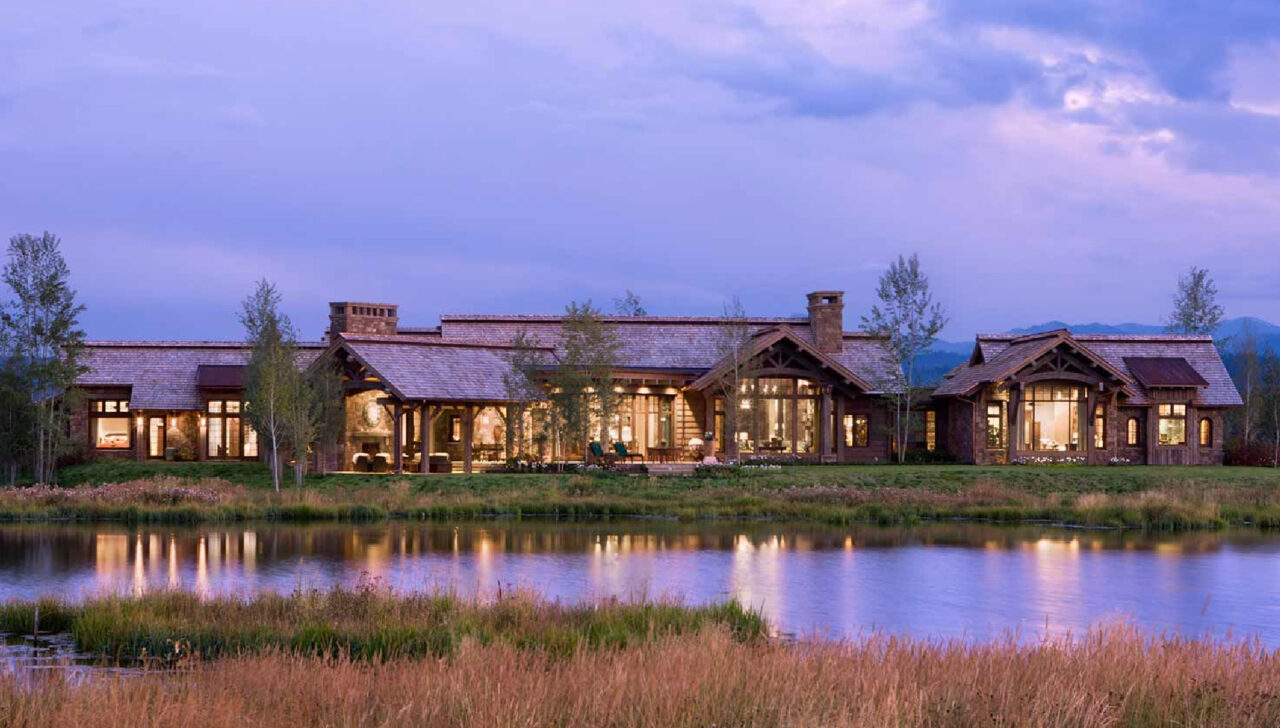 montana home builders exterior pond and patio in the evening