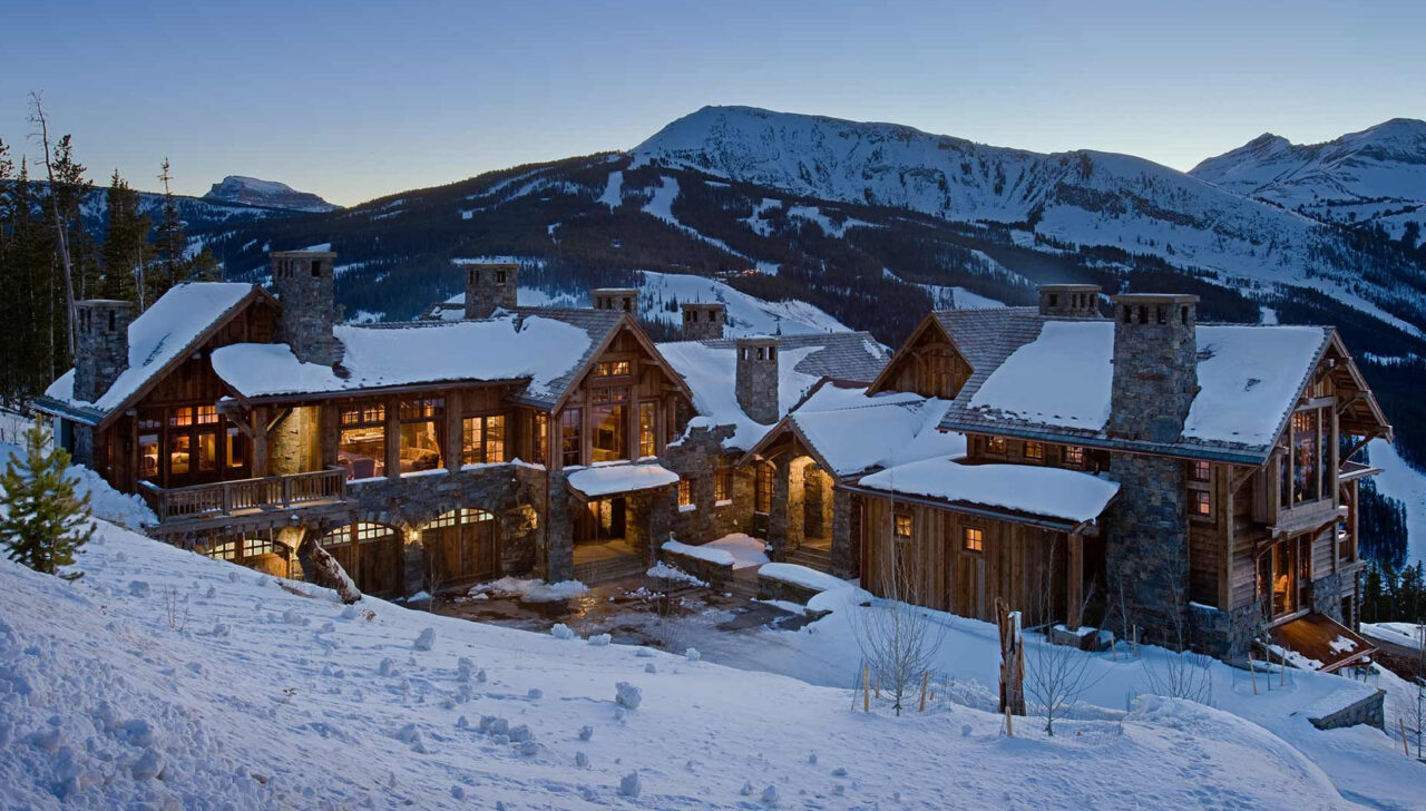 montana home builders exterior house in front of mountain winter