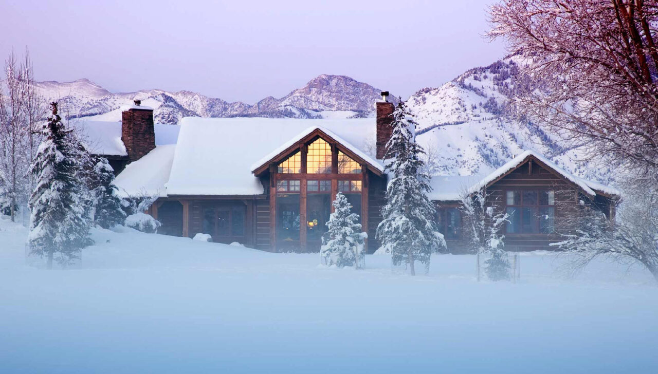 Cabin in the mountains covered in snow.